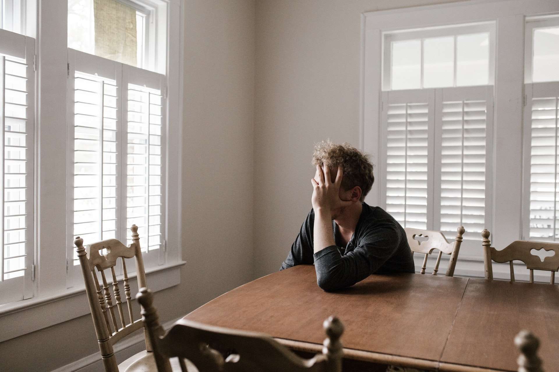 Man worried at a kitchen table