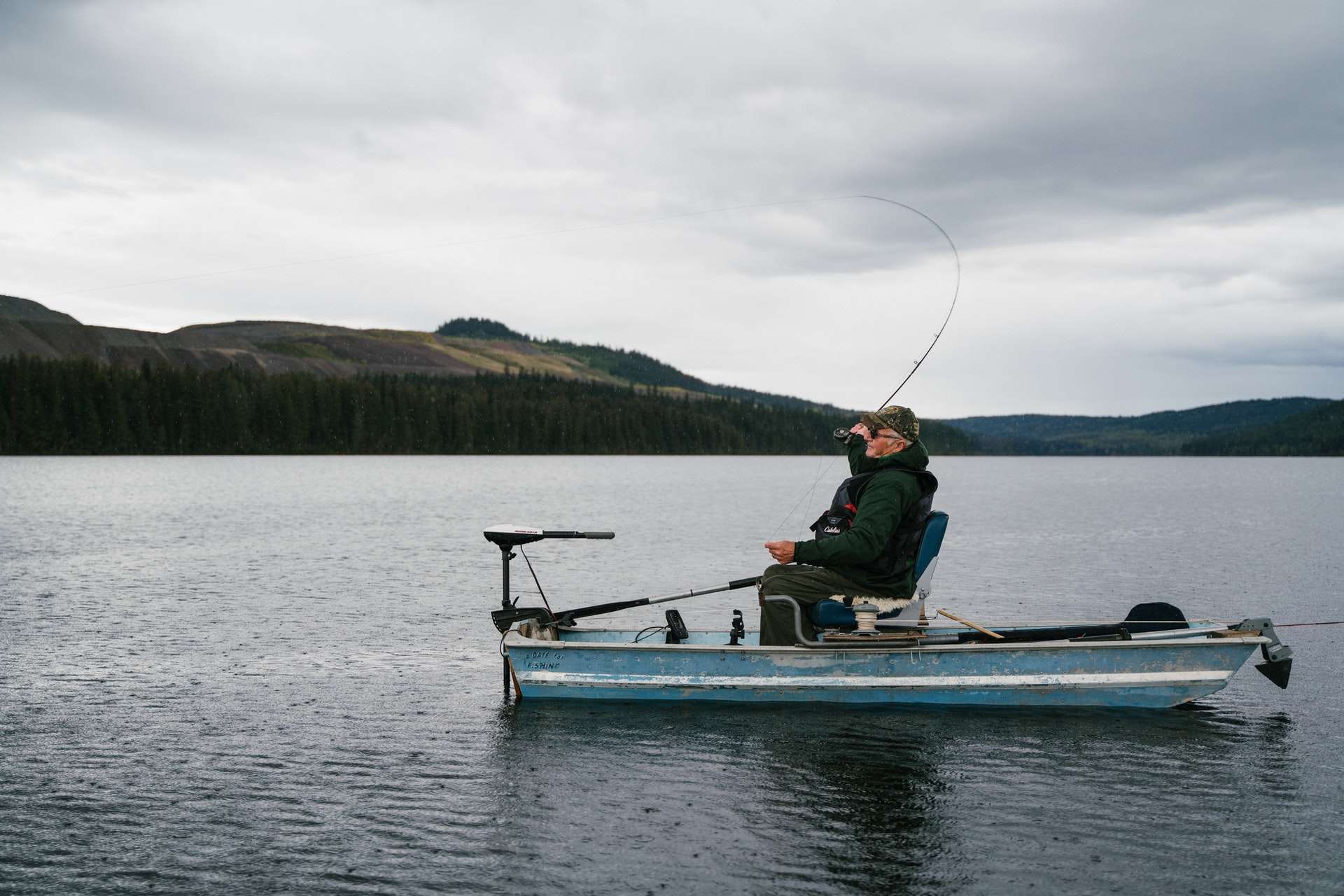 Man Fishing from a boat in a lake