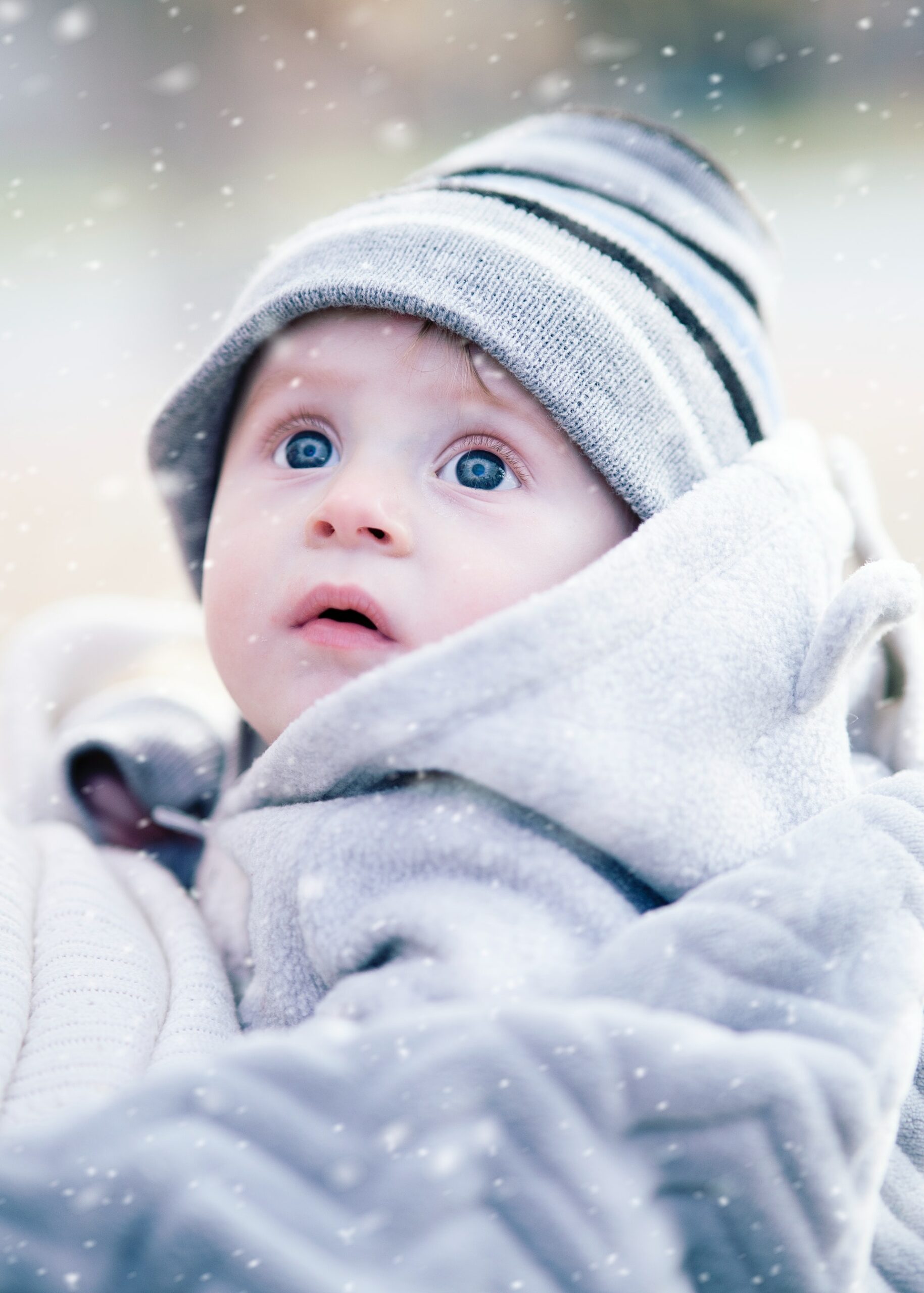 A baby looking innocently at the snow