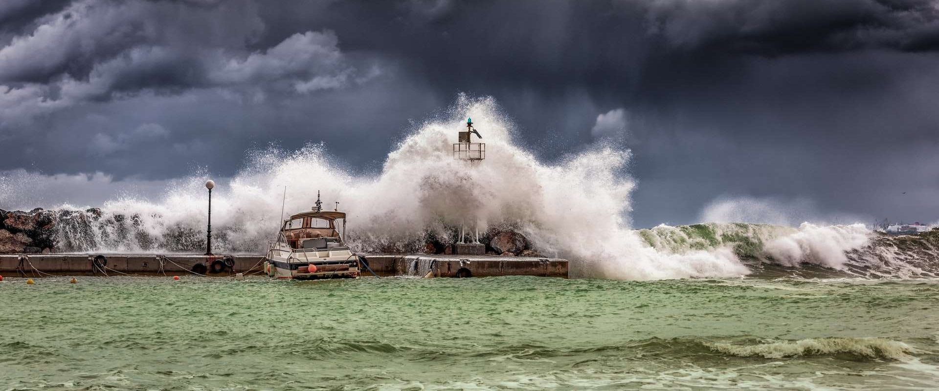 a dock being crashed by waves in a storm