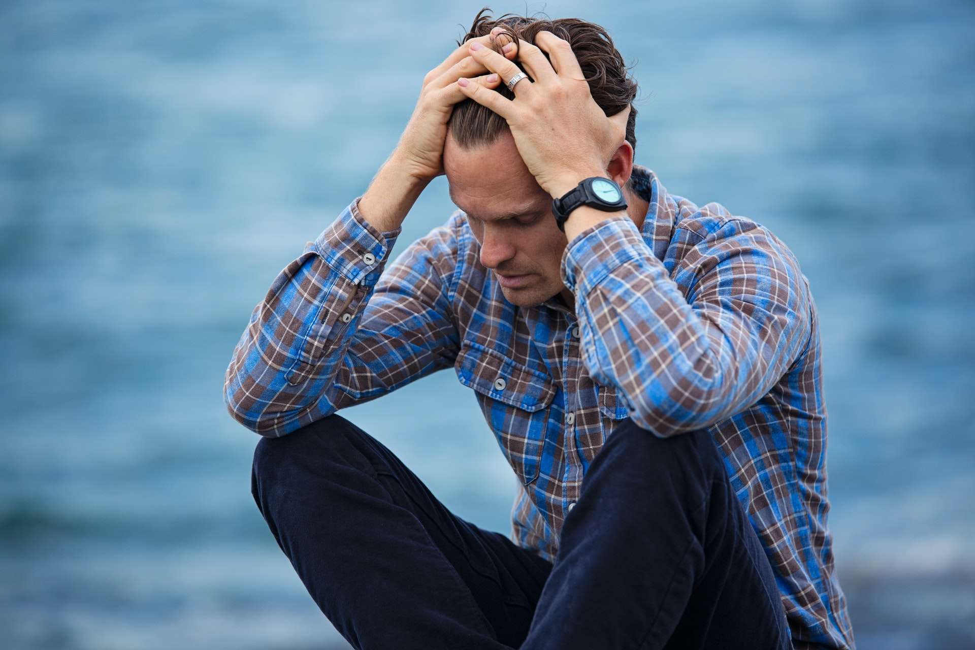 man worried by the water