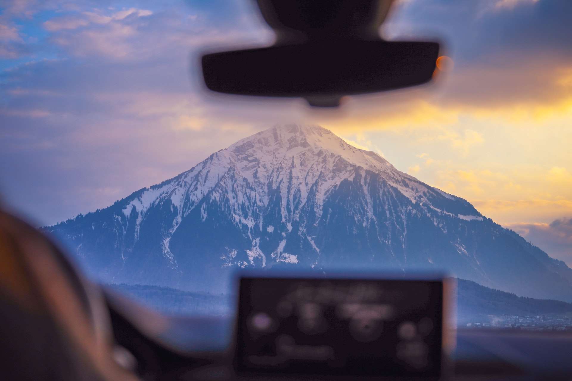 mountain peak as seen through a car window